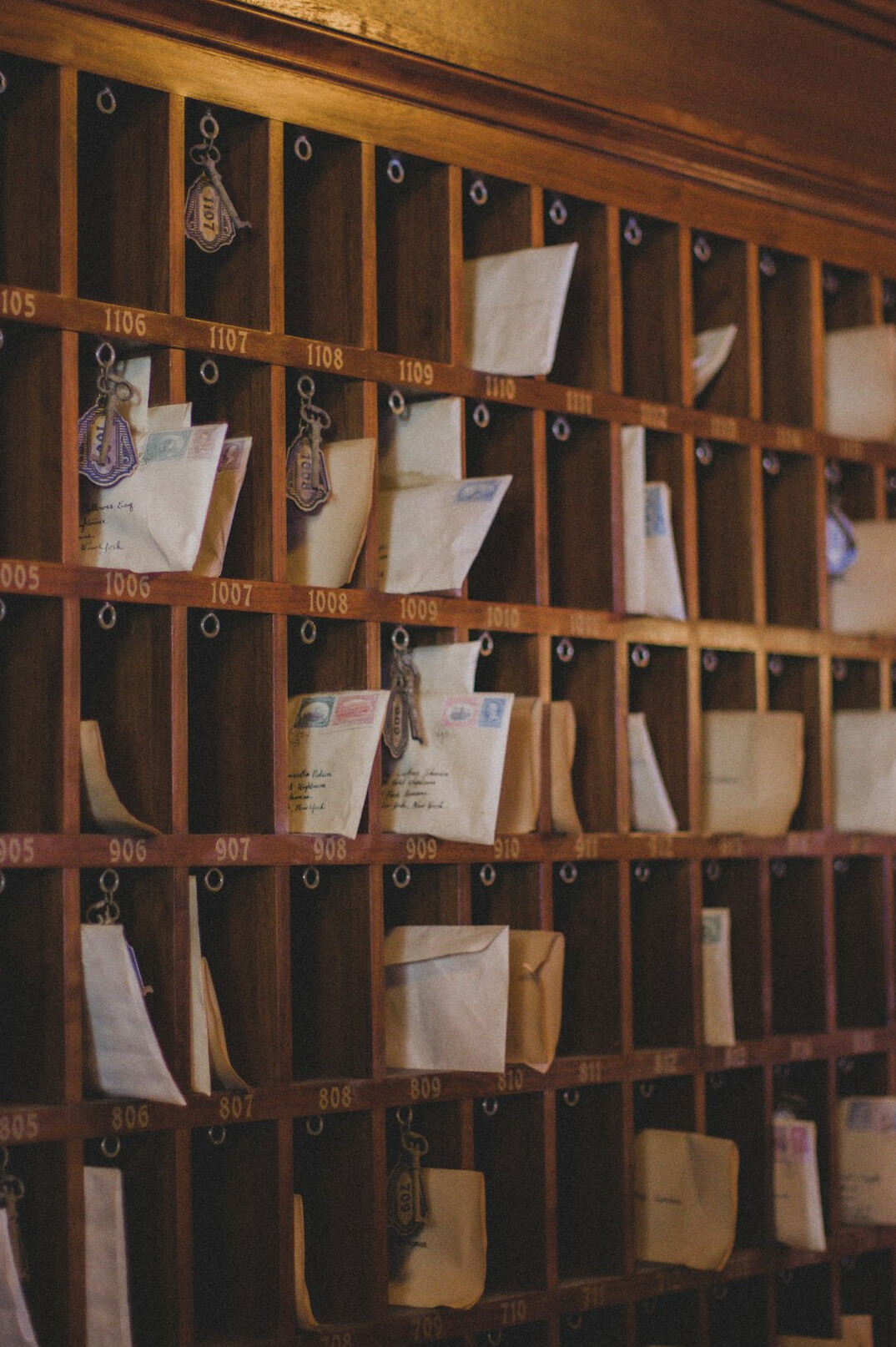 Handwritten letters and envelopes with a brass letter opener on a desk