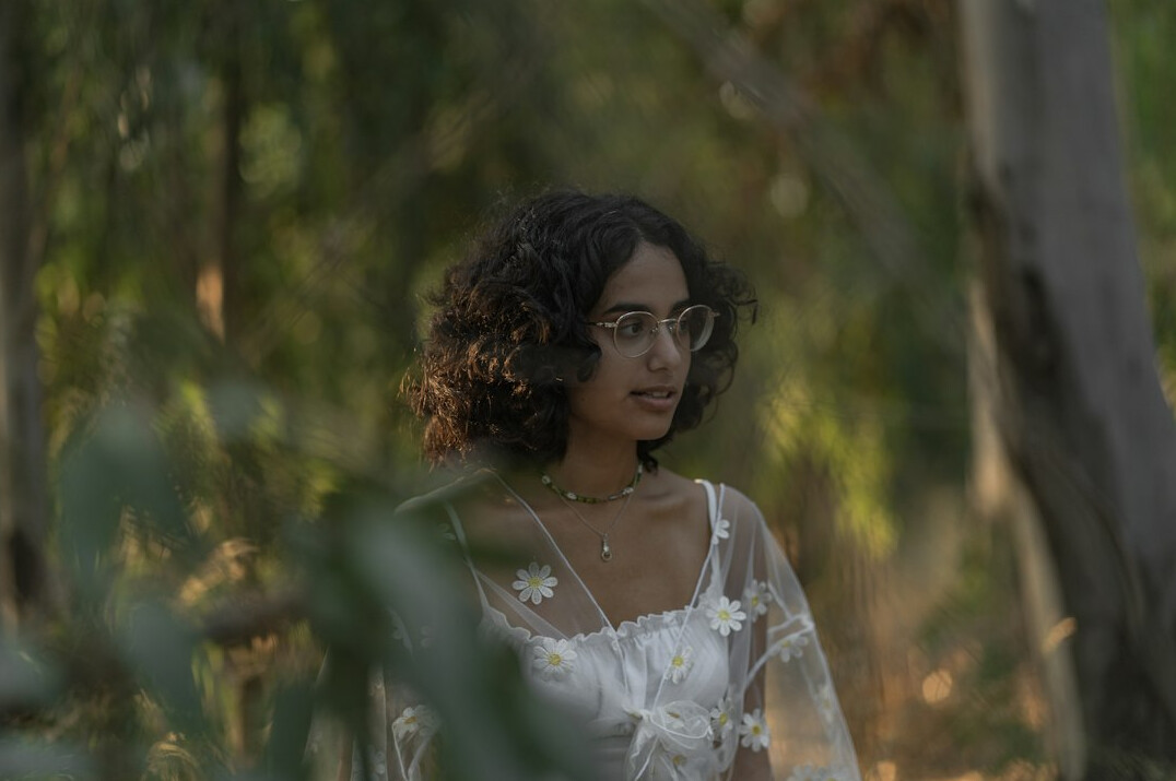 Portrait of a young Latina woman researcher with curly hair