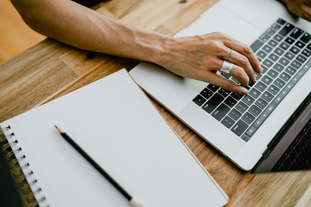 writer typing on laptop