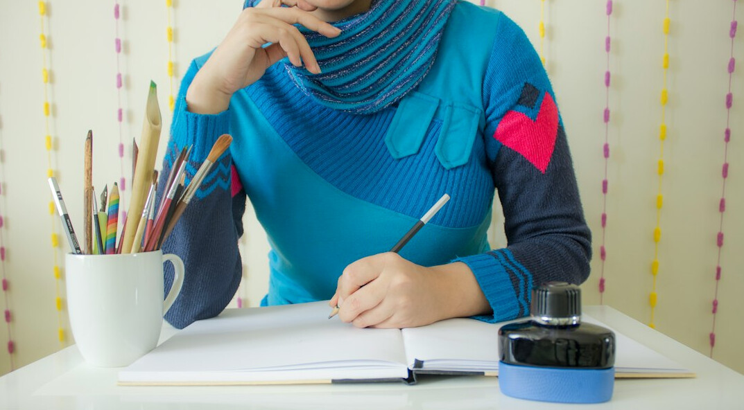 young author writing at desk
