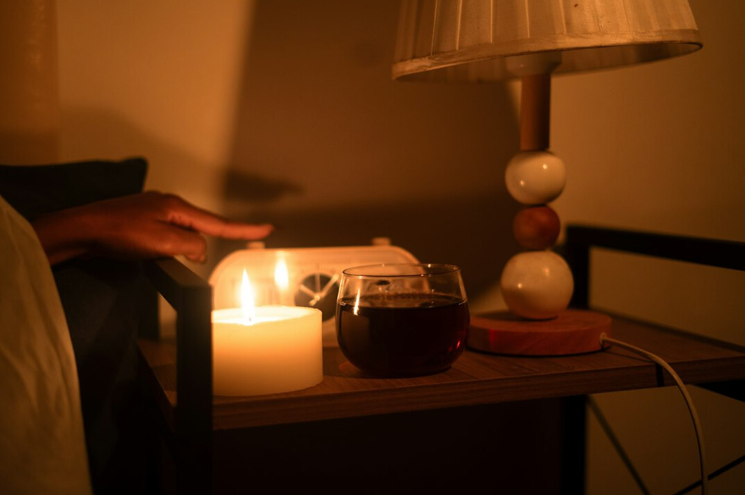 person reading book by lamp
