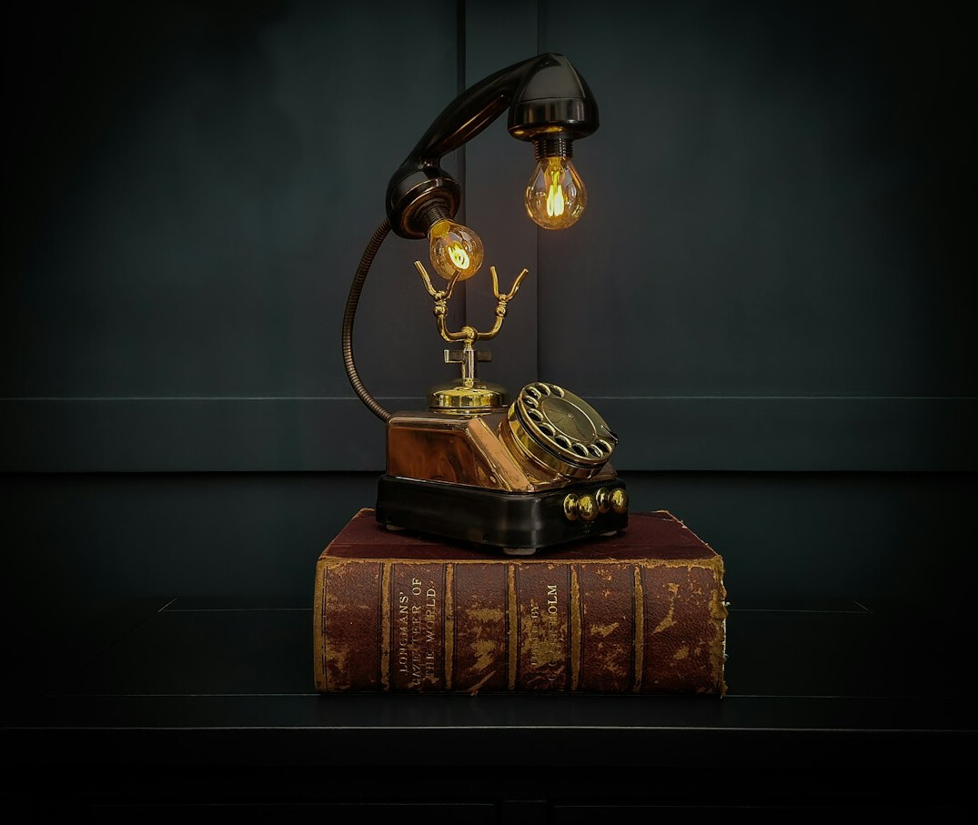 Vintage detective desk with magnifying glass, notebook and brass lamp